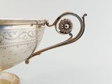 a silver cup that is sitting on a table