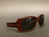 a pair of sunglasses sitting on a table next to each other