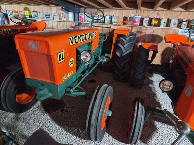 two tractors that are parked in a garage