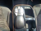 a close up of a car ' s center console with a remote control
