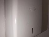 a white paper towel dispenser hanging on the wall