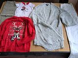 a box of clothes and a sweater on a table