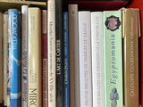 many books that are sitting on a shelf in a box