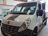 a white van parked in a garage with other cars in the background