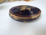 a blue and gold box sitting on a white table