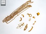 a lot of gold jewelry on a white surface