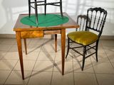 two chairs and a table with a green mat on it