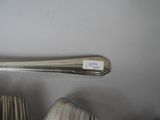 a spoon that is sitting on top of a pile of books