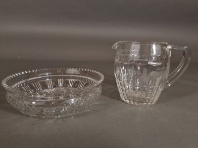 pair of cut glass pitchers and a bowl on a table