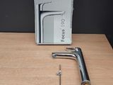 a close up of a faucet on a wooden table with a box