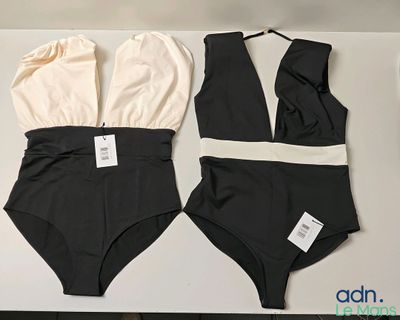 two swimsuits sitting on a table next to each other