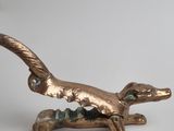 an image of a bronze statue of a dog on a white background