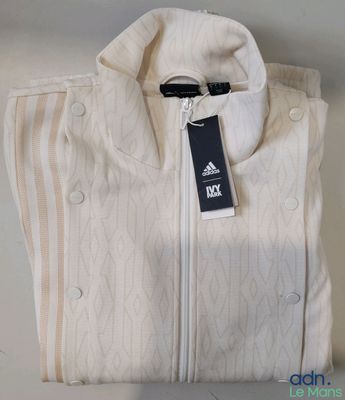 a white shirt with a tag on it sitting on a table