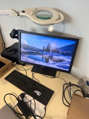 un bureau sur lequel se trouvent un écran, un clavier, une souris et d'autres éléments