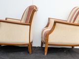 pair of mid - century style armchairs with upholstered arms