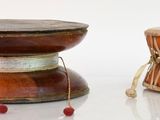 two drums sitting next to each other on a white surface