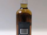 a bottle of whisky sitting on top of a white table