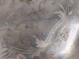 a silver plate with a floral design on it