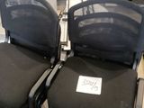 two black chairs that have a price tag on them