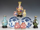five vases and two bowls sitting on a table