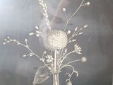 a black and white photo of a vase with flowers in it