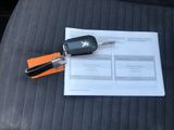 a car key sitting on top of a piece of paper on a car seat