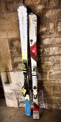 a pair of skis leaning up against a brick wall