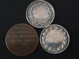 three commemorative medals sitting on top of a table next to each other