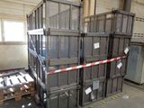 a large stack of crates in a warehouse with red and white tape