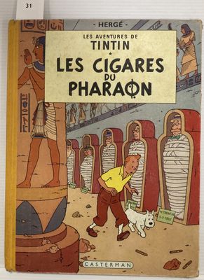 un vieux livre sur lequel figure l'image d'un homme et d'un chien devant un pharaon