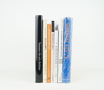 several books are stacked on top of each other on a white surface