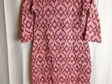 a pink and purple dress hanging on a hanger