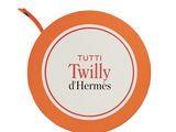 a picture of a orange and white tag with the words tutti twilly d ' hermess
