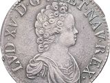 gros plan d'une pièce de monnaie sur laquelle figure un visage de femme