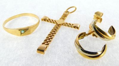 three rings and a cross on a white surface