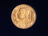 an image of a gold coin in a blue velvet case