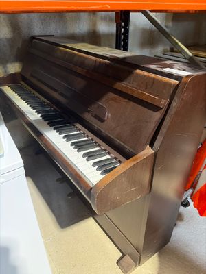 a piano that is sitting on a shelf in a room