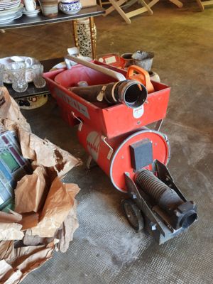 a red cart full of items on the floor