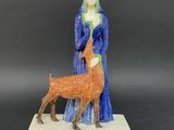 figurine of a woman with a deer on a base