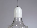 an image of a glass hanging light with a bird on top of it