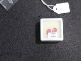 a small square button with two red hearts on it