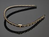 a black and gold headband with a gold chain