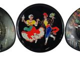 three oval plates with a picture of a woman riding a horse and a man riding a horse