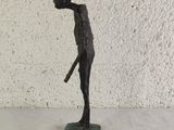 statue of a man holding a baseball bat on a marble base
