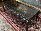a black coffee table on a rug in a living room