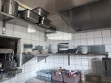 many pots and pans on the shelves in the kitchen