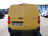 a yellow van that is parked in a parking lot