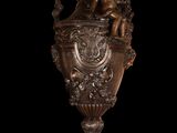 bronze statue of a vase with cherensh and cheres