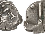 a silver coin with a design on the front and back of it