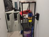 an image of a small room with a shelf and a mop